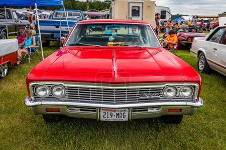 Photo for Iola, WI - July 07, 2022: High perspective front view of a 1966 Chevrolet Impala 4 Door Sedan at a local car show. - Royalty Free Image