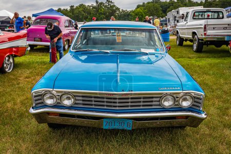 Photo for Iola, WI - July 07, 2022: High perspective front view of a 1967 Chevrolet Chevelle 300 Deluxe 2 Door Sedan at a local car show. - Royalty Free Image