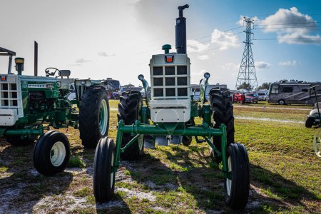 Photo for Fort Meade, FL - February 22, 2022: High perspective front view of a 1966 Oliver 1650 LP High Crop Tractor at a local tractor show. - Royalty Free Image