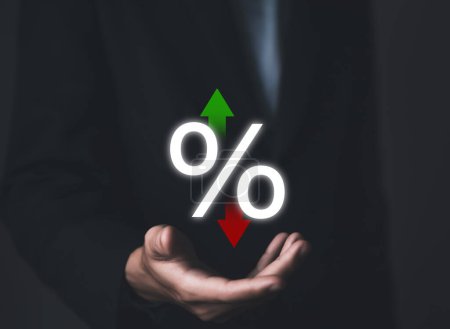 Businessman hand showing percentage icon and up or down arrow Business concept, finance, economy, mortgage, bank interest rate, loan, investment, stock growth and dividends.