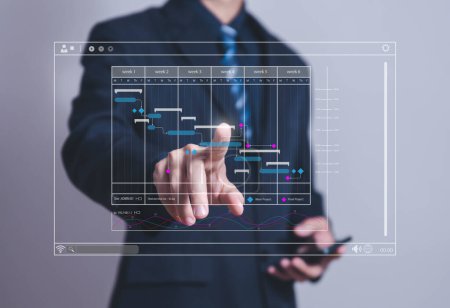 Photo for Male manager managing business planning project schedule in the office. Gantt chart showing on virtual screen. business people manage computer data in digital technology on the internet - Royalty Free Image