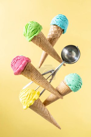 Téléchargez les photos : Flying colorful ice cream scoops in cones, bright background. Levitation. High quality photo - en image libre de droit