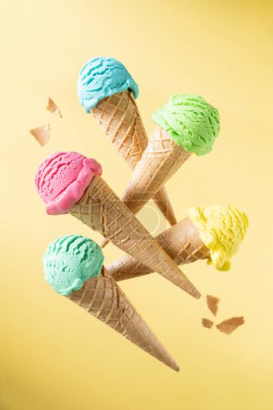 Photo for Flying colorful ice cream scoops in cones, bright background. Levitation. High quality photo - Royalty Free Image