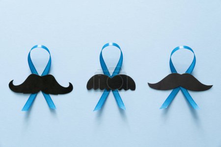 Photo for Movember concept - event to raise awareness of mens health issues, moustache anf blue ribbon, top view - Royalty Free Image