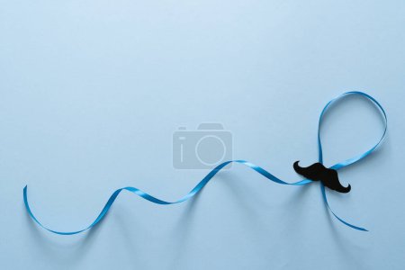 Photo for Movember concept - event to raise awareness of mens health issues, moustache anf blue ribbon, top view - Royalty Free Image