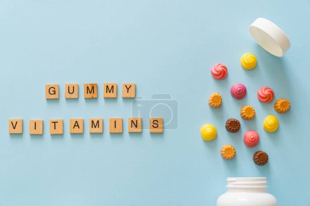 Photo for Gummy vitamins concept - chewy vitamin alternative for kids, bright blue background - Royalty Free Image