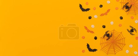 Photo for Halloween concept - creative backgrtound with festive sweets, spiders, bats, top view - Royalty Free Image