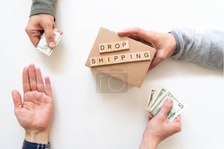 Photo for Drop shipping concept - hands exchanging money and product, top view - Royalty Free Image
