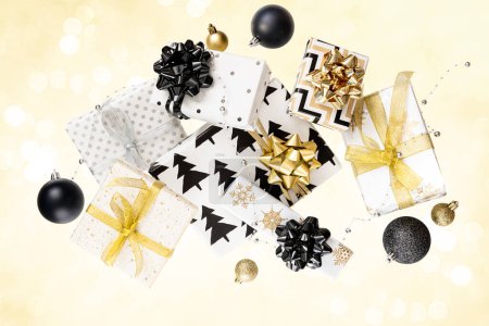 Photo for Creative composition of festive present boxes. Free levitation. Black and gold colors. High quality photo - Royalty Free Image