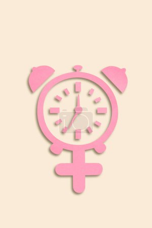 Photo for Menopause concept - paper cutout combination of female symbol and alarm clock, top view - Royalty Free Image
