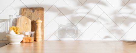 Photo for Kitchen background with cutting board, utencils, groceries, direct sunlight, shadows from trees. High quality photo - Royalty Free Image