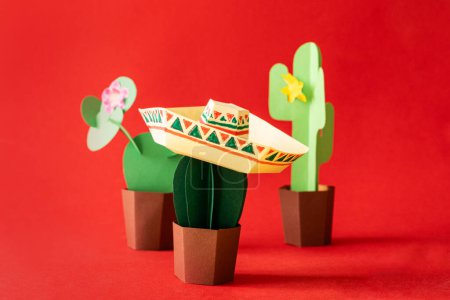 Photo for Cinco de Mayo concept - paper craft cactus in sombrero on solid color background. High quality photo - Royalty Free Image