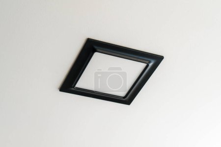 Foto de Black plastic rectangular LED lamp isolated on a white ceiling. - Imagen libre de derechos