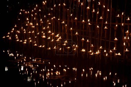 The candlelight reflected on the water surface at night.