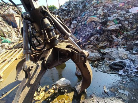 Grab crane with big pile of garbage, garbage separation, waste separation factory