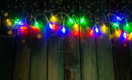Foto de Colourful lights on wooden table with copy space - Christmas celebration theme. - Imagen libre de derechos