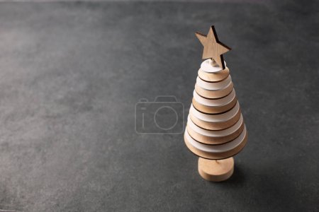 Téléchargez les photos : Arbre de Noël créatif fabriqué à partir de cercles en bois sur fond sombre. Vue supérieure avec espace de copie - en image libre de droit