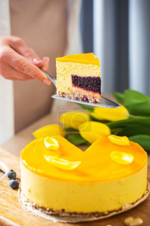 Photo for Woman holds no baked raw cake made with dates, cashews and mango. High quality photo - Royalty Free Image
