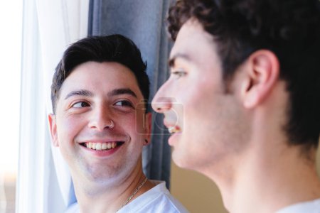 Photo for Gay couple sharing a special moment in the morning by the window. Homosexual romantic tenderness. High quality photo - Royalty Free Image
