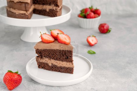 Naked chocolate cake with cream and fresh strawberries on top. Rustic style. Selective focus. Copy space