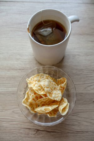 traditional Indonesian snack from Surabaya, featuring sweet tempeh sagu chips and a cup of tea