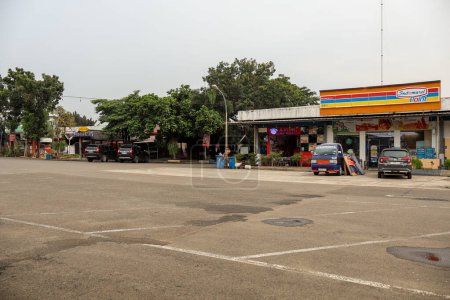 Photo for Purwakarta, Indonesia - June 3rd - Spacious Paved Parking Area at Highway Rest Stop in Purwakarta km 72, Indonesia, Southeast Asia. With Indomaret, Yomart shop retail, - Royalty Free Image