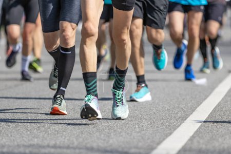 Photo for Legs of a group of runners at the hamburg marathon - Royalty Free Image