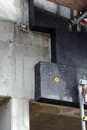 black polystyrene insulation on concrete wall