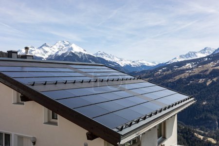 Photo for House roof with solar panels in the Swiss Alps - Royalty Free Image