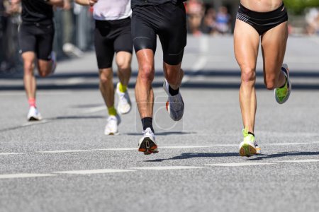 Legs of male and female runners during marathon