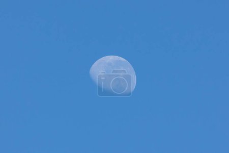 Foto de The waning moon in a blue sky. Nature. - Imagen libre de derechos
