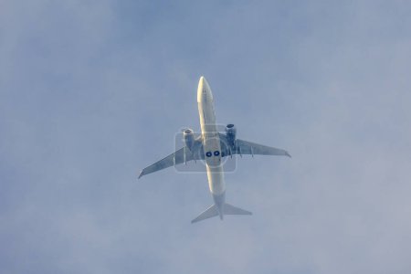 Photo for A jet plane flying in a blue sky between clouds. Transportation. Air travel. - Royalty Free Image
