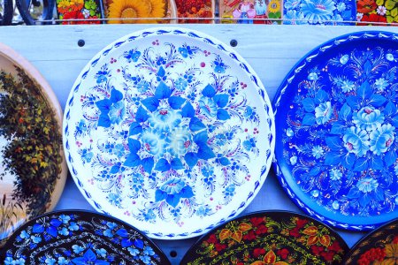Photo for Wooden plates with Petrikov paintings at the fair in Ukraine - Royalty Free Image