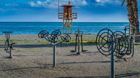 Lifeguard tower and gymnastics equipment on Almunecar beach, Granada, Andalucia, Spain. High quality photo