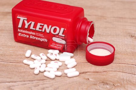 Photo for WASHINGTON, USA - October 15, 2022: Bottle Of Tylenol Extra Strength With Many Pills On A Wooden Table Which Was Sold Out During Covid-19 time, headache, Painkillers. - Royalty Free Image