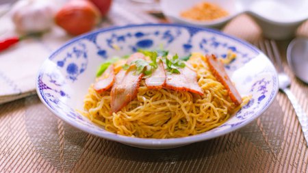 Photo for Egg Noodles with Barbeque Pork in Chinese Style Plates on a Wooden Table with Tea and - Royalty Free Image