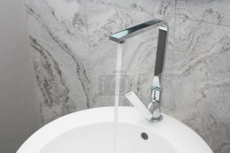 Photo for Modern faucet with running water in the bathroom, stock photo - Royalty Free Image