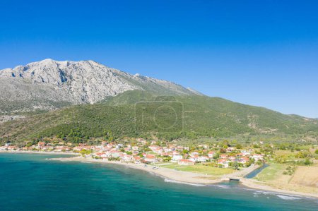 Photo for This landscape photo was taken, in Europe, in Greece, in Aetolia Acarnania, in Kato Vasiliki towards Patras, by the Ionian Sea, in summer. We see the city on the rocky coast in the middle of the green countryside, under the sun. - Royalty Free Image
