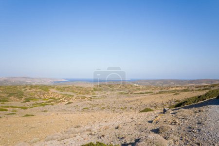 This landscape photo was taken, in Europe, in Greece, in Crete, towards Sitia, At the edge of the Mediterranean Sea, in summer. We see the arid countryside in the middle of the mountains, under the sun.
