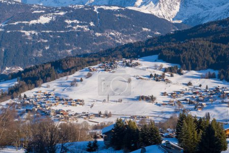 Foto de Esta foto de paisaje fue tomada en Europa, en Francia, en los Alpes del Ródano, en Saboya, en los Alpes, en invierno. Vemos los chalets de la ciudad de Megeve en el macizo del Mont Blanc, bajo el sol. - Imagen libre de derechos