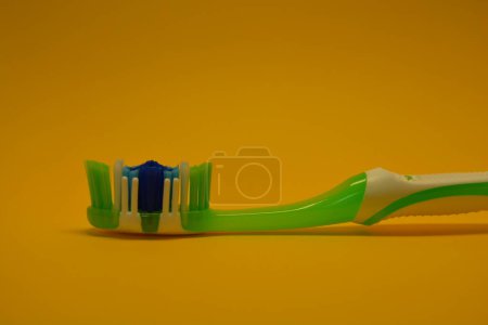 Things, personal hygiene products, new toothbrush placed on yellow background.