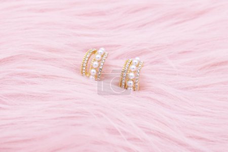 Photo for Earrings jewelry, Close up of a pair of luxury earrings on a pink background. Elegant earrings for women. - Royalty Free Image
