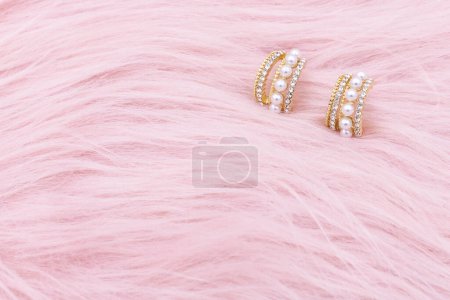 Photo for Earrings jewelry, Close up of a pair of luxury earrings on a pink background. Elegant earrings for women. - Royalty Free Image