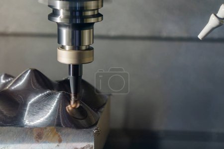 Photo for The CNC milling machine rough cutting the mold parts by indexable ball tools. The mold and die manufacturing process by machining center with the solid endmill tools. - Royalty Free Image