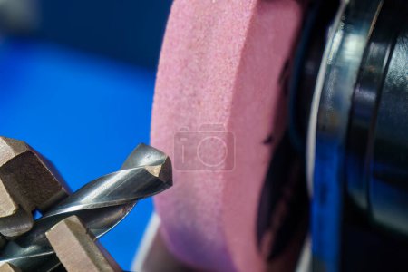 Photo for Close up scene the drill tool regrinding process with abrasive stone wheel. The tool regrinding process for CNC milling machine. - Royalty Free Image