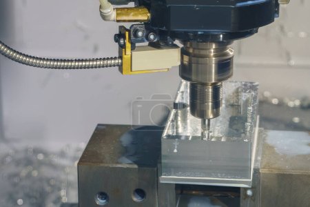 The CNC milling machine rough cutting the aluminum housing with flat end mill tool. The mold and die manufacturing process by machining center with the solid endmill tools.