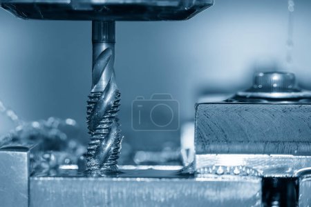 Photo for Close up scene the machine tapping process the metal plate by CNC milling machine. The thread cutting process by canned cycle. - Royalty Free Image