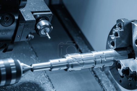 Photo for The CNC lathe machine slot milling the brass shaft parts by milling spindle. The high technology metal working with CNC turning machine. - Royalty Free Image
