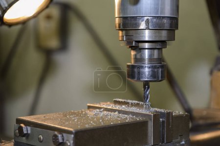 The slot cutting  process on NC milling machine with flat end mill tools. The metal working concept on the milling machine.