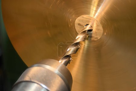 Photo for The hole drilling process on brass material parts by lathe machine. The parts production on turning machine. - Royalty Free Image